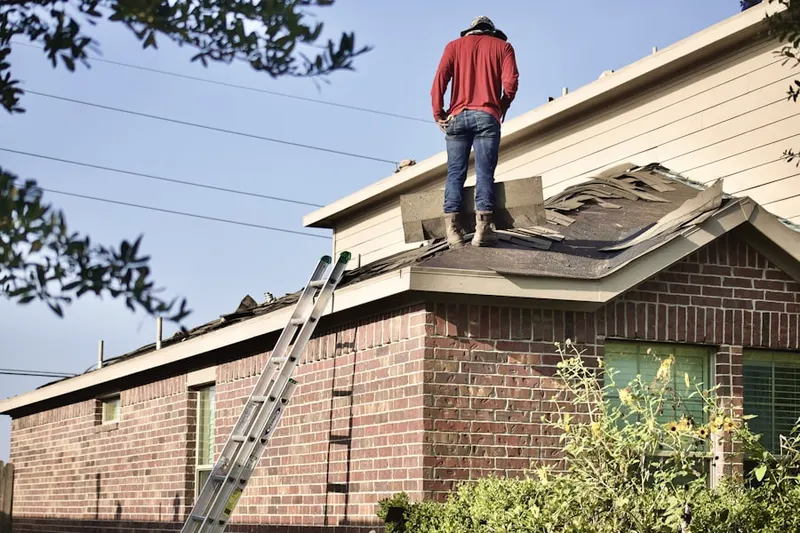 Professional roofer working on a residential roof in Mansion Park